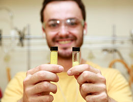 Photo of a student holding up test tubes. Links to Photo of a smiling woman. Links to Gifts That Pay You Income
