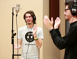Photo of two students in a recording studio. Links to What to Give.